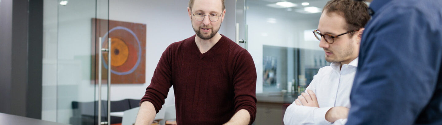 Three people looking at plans